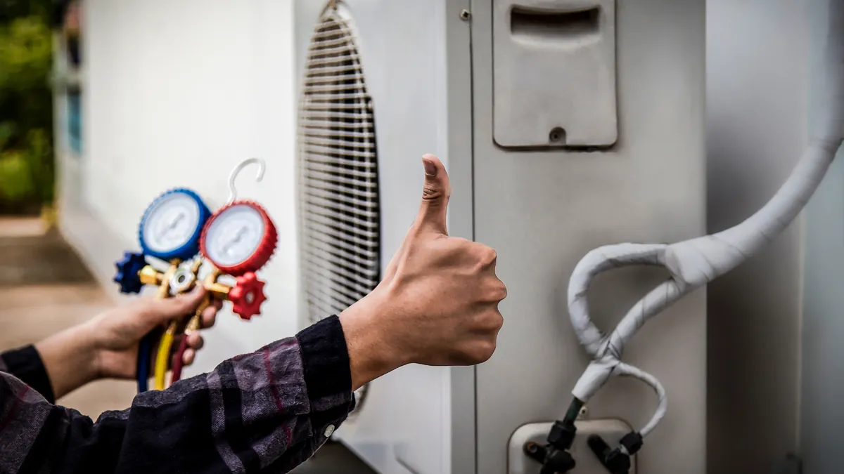 HVAC technician checking a heat pump