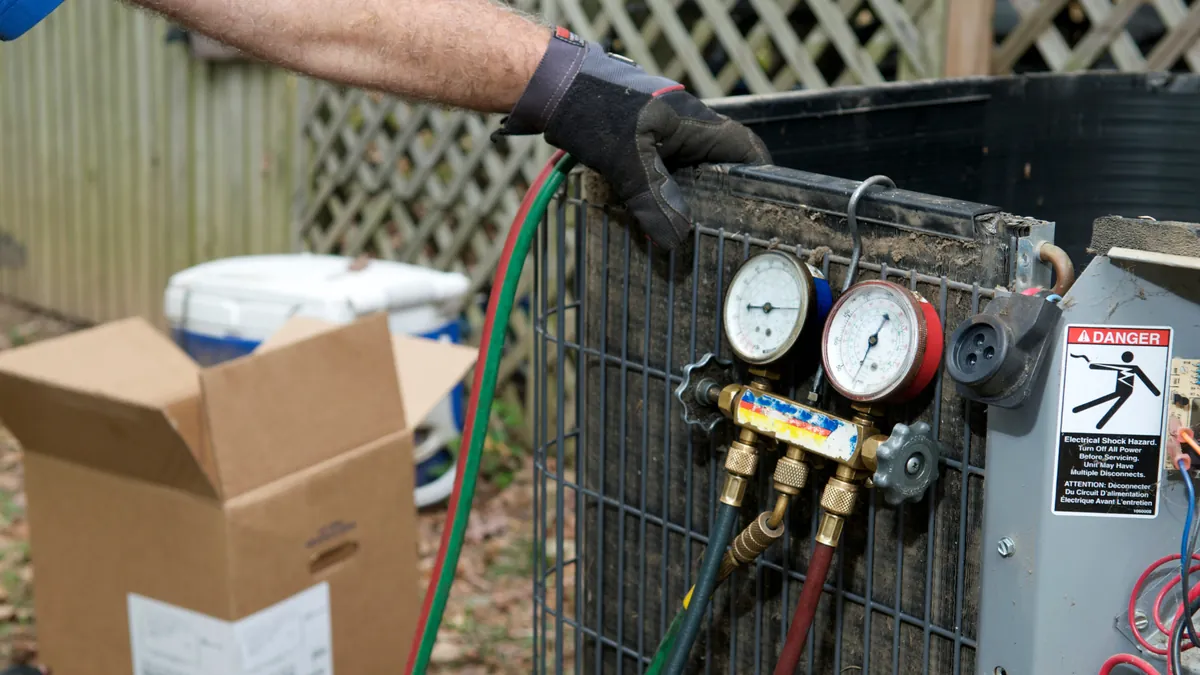 Technician servicing an outdoor AC unit